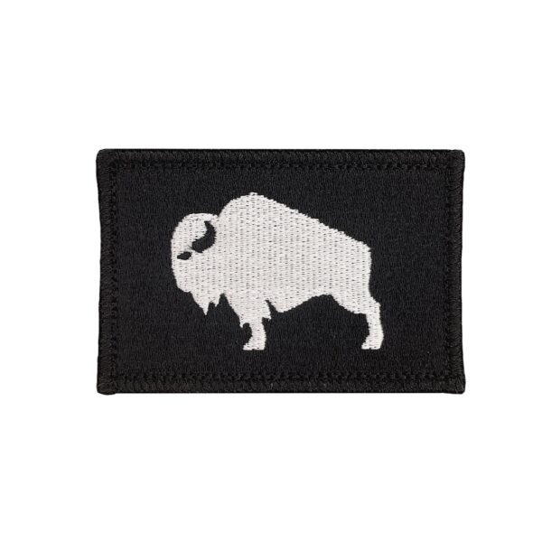 An embroidered 2"X 3" patch that has an American Bison, Buffalo, Ox, bull, with a velcro hook and loop backing. The Bison is white with a black background and black boarder. Tactical gear accessories. Very Popular.
