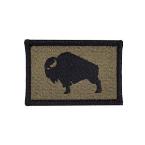 An embroidered 2"X 3" patch that has an American Bison, Buffalo, Ox, bull, with a velcro hook and loop backing. The Bison is black with a olive drab background and black boarder. Tactical gear accessories. Very Popular.