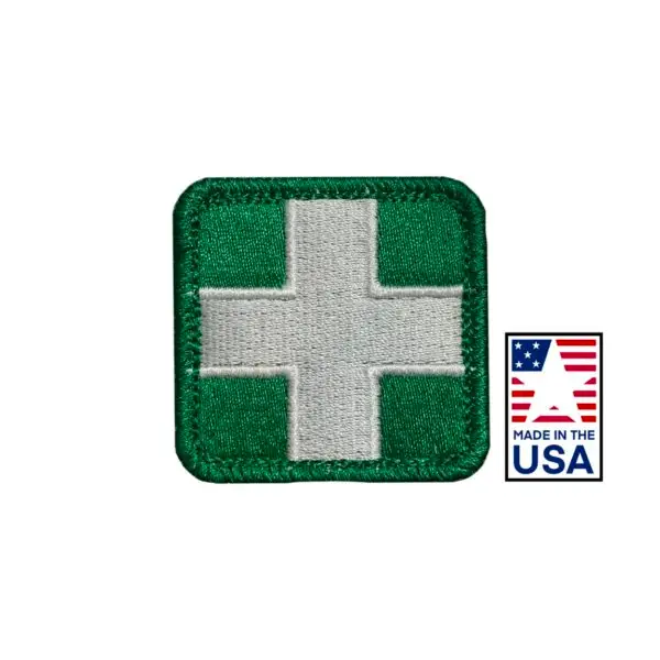 Green and White 2x2 inch embroidered medical patch featuring a red cross design, hook and loop backing, made in USA for healthcare uniforms.