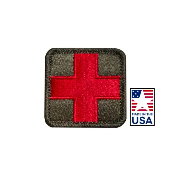 2x2 inch embroidered medical patch with red cross design, made in the USA. Quality detailing, hook and loop fasteners, ideal for healthcare uniforms and accessories.