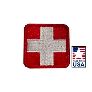 Red and White 2x2 inch embroidered medical patch featuring a red cross design, hook and loop backing, made in USA for healthcare uniforms.