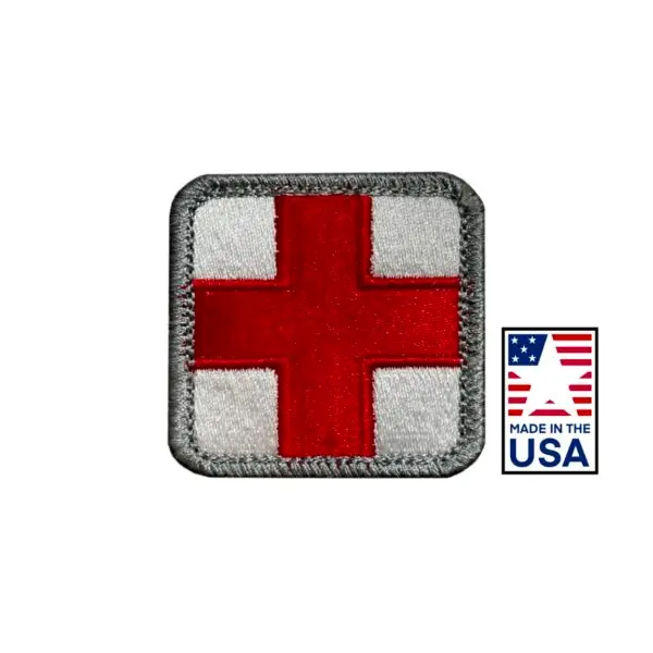 2x2 inch embroidered medical patch with red cross design, made in the USA. Quality detailing, hook and loop fasteners, ideal for healthcare uniforms and accessories.