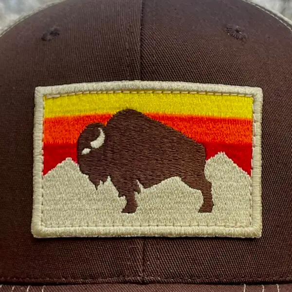 Image of a Brown Snapback Cap with American Bison Sunset Patch. USA-made, athletic fit, adjustable, perfect for active and patriotic styles.