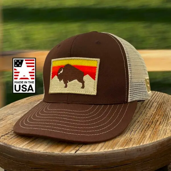 Image of a Brown Snapback Cap with American Bison Sunset Patch. USA-made, athletic fit, adjustable, perfect for active and patriotic styles.